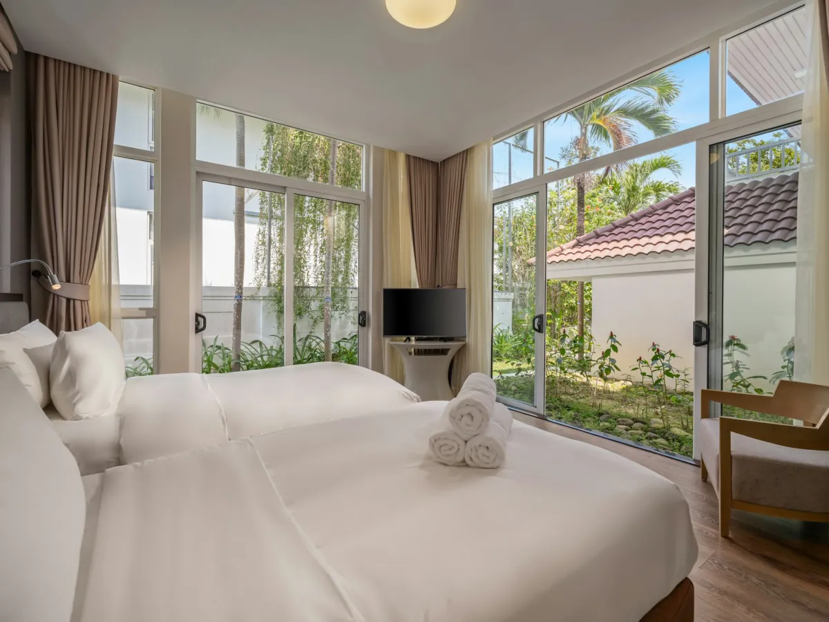 Phòng nhóm 6 người ở Tuy Hòa: giường trải ga trắng, cửa kính lớn nhìn ra cây xanh (ảnh minh họa)